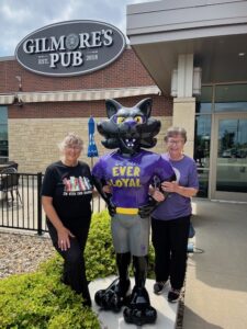 Mary and Ardelle at TC statue at Gilmore's Pub outside Diamond Event Center.